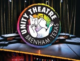 Logo of Unity Theatre in Brenham, Texas, featuring two theatrical masks in a colorful circle.