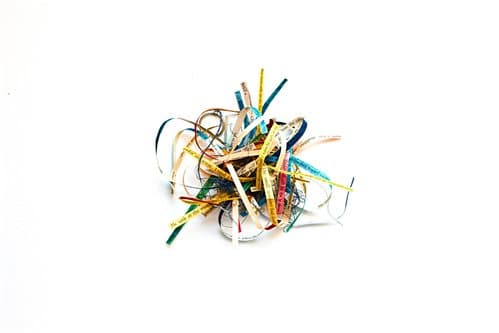 A colorful bundle of shredded paper strips on a white background.